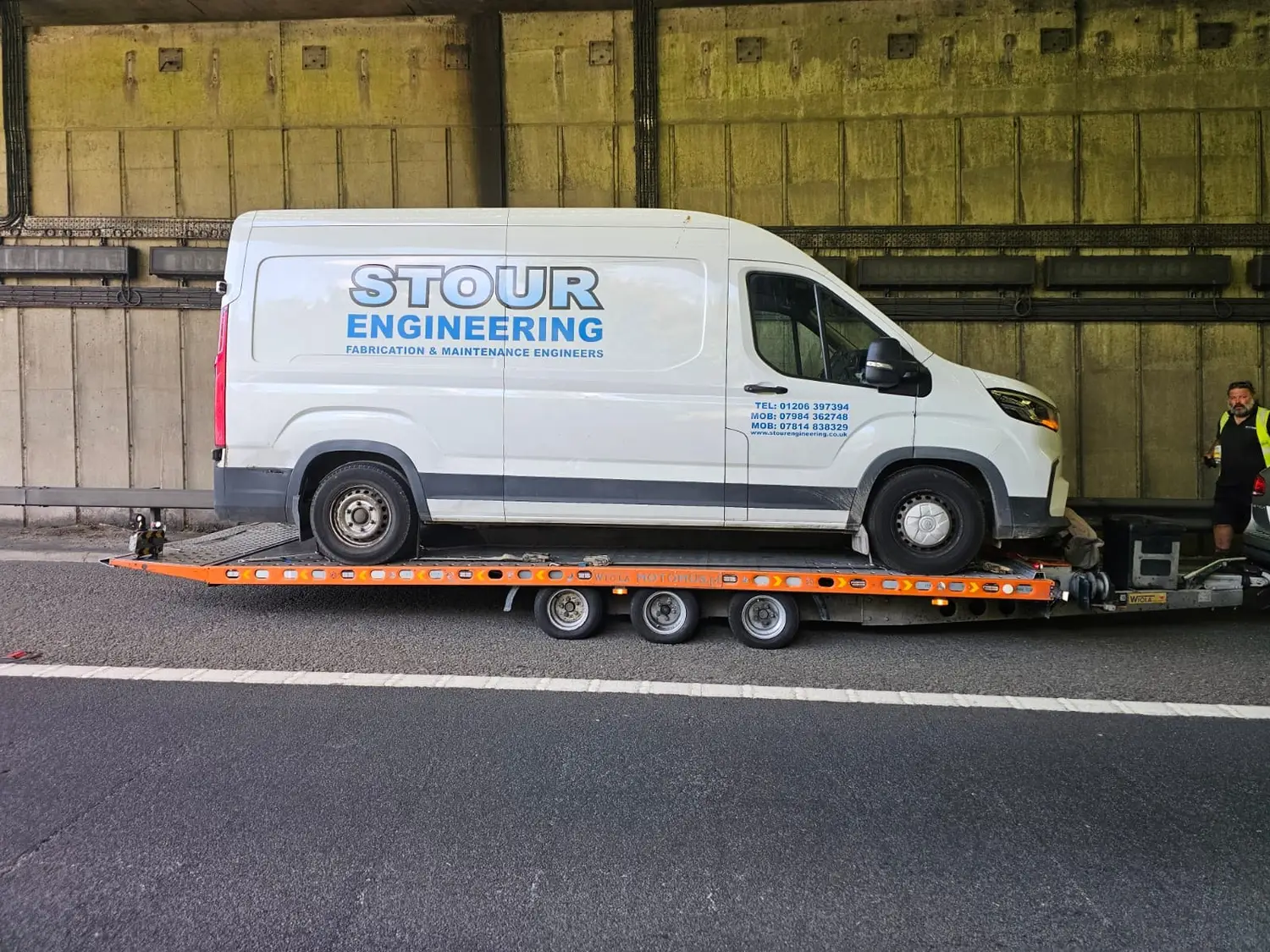 Broken-down van recovered from a motorway underpass onto a flatbed by Essex Breakdown Recovery